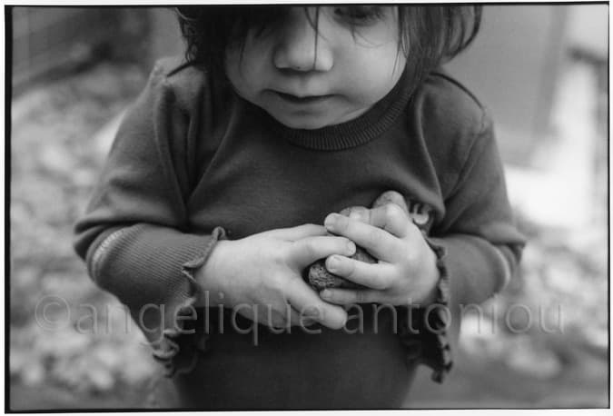 Black and white children photograph titled My Rocks by Angelique Antoniou