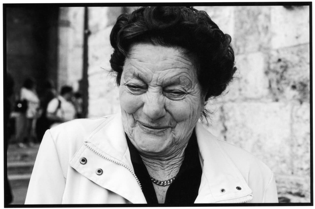 Black and white people photograph titled Maria Smiles by Angelique Antoniou